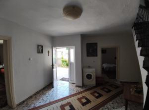 ein Wohnzimmer mit einer Treppe und ein Zimmer mit einer Tür in der Unterkunft Cozy Room in the Old Town in Gjirokastër