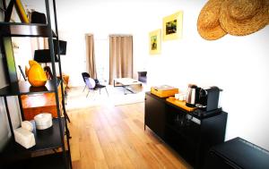 a living room with a desk and a room with at Bella Vista Hôtel, Suites & Maisons in Porticcio