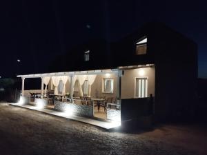 a house with a lit up patio at night at Imeros house in Ímeros