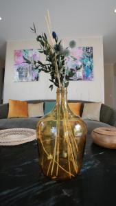 a vase with flowers in it sitting on a table at Bella Vista Hôtel, Suites & Maisons in Porticcio
