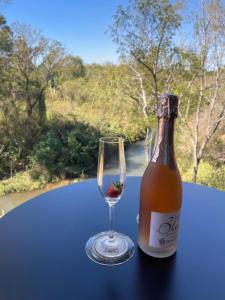 a bottle of wine and a glass on a table at Modern Apartment on Letaba River in Tzaneen
