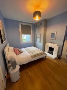 a bedroom with a bed and a fireplace at The Palms Brighton in Brighton & Hove