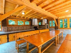 a dining room with a wooden table in a cabin at Вила Деа in Kotel