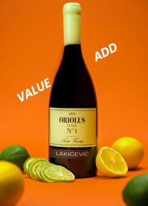 a bottle of wine next to lemons and oranges at SLAVNA - Luxe & Wine by the Fortress in Belgrade