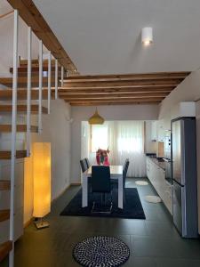 a kitchen with a table and a dining room at Flavour Trip Apartment in Shkodër +21 photos