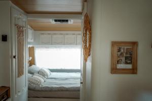 a bedroom with a bed in a small room at Каравана Бохемия in Chernomorets