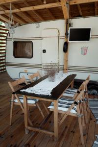 a table and chairs in front of an rv at Каравана Бохемия in Chernomorets