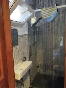 a bathroom with a sink and a shower at La Casa de Conchi in Comillas
