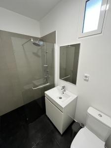 a bathroom with a sink and a shower and a toilet at Ribeira Roots Residence in Santa Cruz