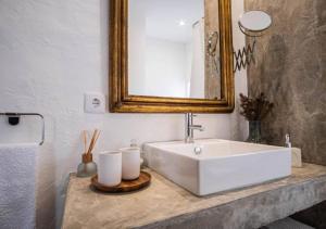 a bathroom with a white sink and a mirror at Casa do Largo in Torres Vedras