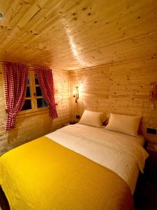 a bedroom with a bed in a wooden room at Etno kuca Lana in Mojkovac