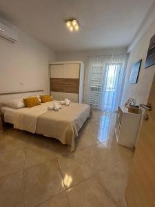Postel nebo postele na pokoji v ubytování Apartmani Palada
