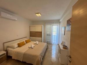 Postel nebo postele na pokoji v ubytování Apartmani Palada