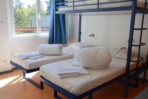 two bunk beds in a room with towels on them at Auberge de Jeunesse de Mulhouse in Mulhouse
