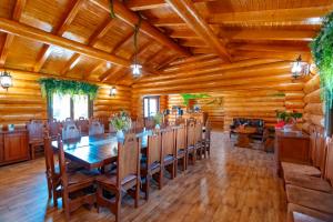 a dining room with a long table and chairs at Cabana Nemtisor in Nemţişor