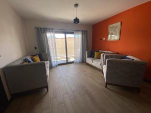 a living room with two couches and a window at Apartamento #12 Portal de Occidente in Quetzaltenango +1 photo