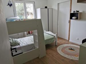 a small room with a bunk bed and a small bedroom at Agréable Villa proche Pont du Gard in Bezouce