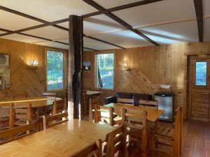 a dining room with wooden tables and chairs at Rustic Beaverfoot Lodge Room N5 in Parson