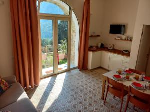 a living room with a table and a large window at Villa Annamaria - b&b in Ballabio