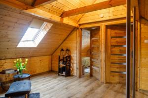 a room in a log cabin with a skylight at Kresy in Wajków