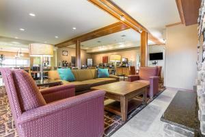 a lobby with a couch and chairs and a table at MainStay Suites Sidney - Medical Center in Sidney