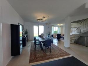 a dining room and living room with a table and chairs at Villa Doris in Lazise