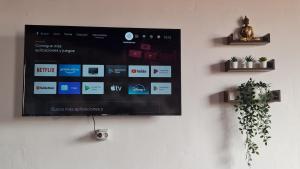 a flat screen tv hanging on a wall at Los Cerrajones: spectacular views from the cliff in Agulo