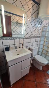 a bathroom with a white sink and a toilet at Los Cerrajones: spectacular views from the cliff in Agulo