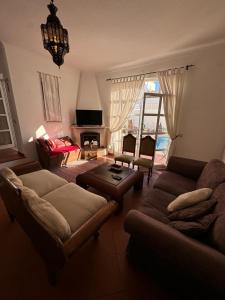 a living room with two couches and a tv at Villa 46 Hostel in Lagos