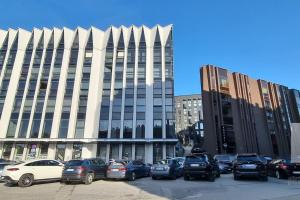 a parking lot with cars parked in front of a building at Charming flat next to Old Town and Harbor in Tallinn