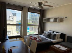 a living room with a bed and a large window at Charming flat next to Old Town and Harbor in Tallinn