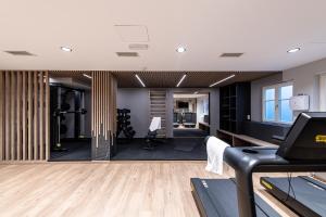 an office with a gym with a treadmill at HOTEL POST alpine cityflair in Brunico