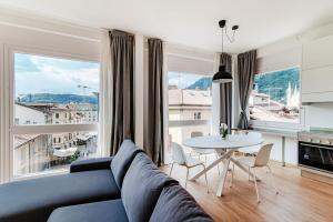 a living room with a couch and a table at Downtown Como-Luxury Suites in Como