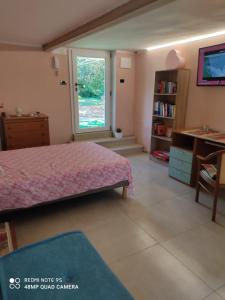 a bedroom with a bed and a window at Il giardino del Sole in Galatone