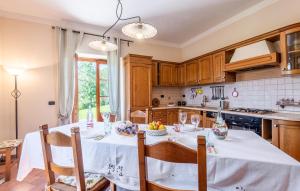 a kitchen with a table with a white table cloth at Pet Friendly Home In Arezzo With Wifi in Palazzo del Pero