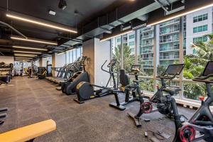 a gym with treadmills and cardio equipment in a building at Sky-High oasis Large Studio POOL & GYM in Miami