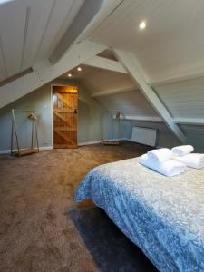 a bedroom with a large bed in a attic at Plasbach Cottage in Llandeilo +17 photos