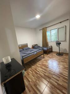a bedroom with a bed and a desk with a lamp at Nikolla's apartment in Himare
