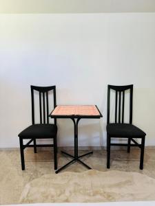 two chairs and a table and a table and two chairs at Dolce vita cottage - waterfront in Bihać