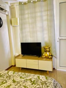 a television sitting on a dresser in a bedroom at FABULEUX STUDIO Centre ville Fort De France Martinique CAPITALE in Fort-de-France +21 photos
