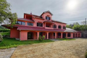 a large red house with a driveway in front of it at Villa Noiram - Your dream Getaway in Nature in Senožeče