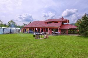 a house with a large yard with a greenhouse at Villa Noiram - Your dream Getaway in Nature in Senožeče +29 photos