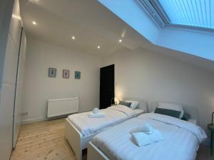a bedroom with two beds with towels on them at Old Town Suites in Malmedy