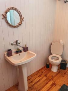 a bathroom with a sink and a toilet at Каравана GYPSY in Chernomorets