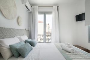 Postel nebo postele na pokoji v ubytování Aurora - Rooms & Suites - Spetses