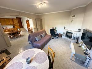 a living room with a couch and a table at Villa Polina in Leiria