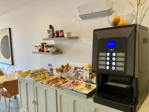 a microwave oven sitting on top of a counter with pastries at Castello Prime Suites in Lisbon