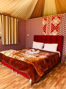 a bedroom with a large bed in a room at WADI RUM-Bedouin Tents and Jeep Tours in Wadi Rum