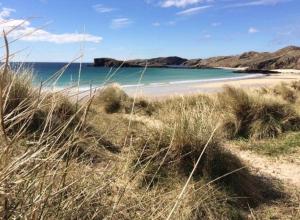 a sandy beach with the ocean in the background at Eco Crofter's Wagon by the Sea - Off Grid Experience - No electricity - As seen soon on Netflix in Oldshoremore