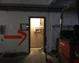 a room with a door with a red arrow on it at Eco Crofter's Wagon by the Sea - Off Grid Experience - No electricity - As seen soon on Netflix in Oldshoremore